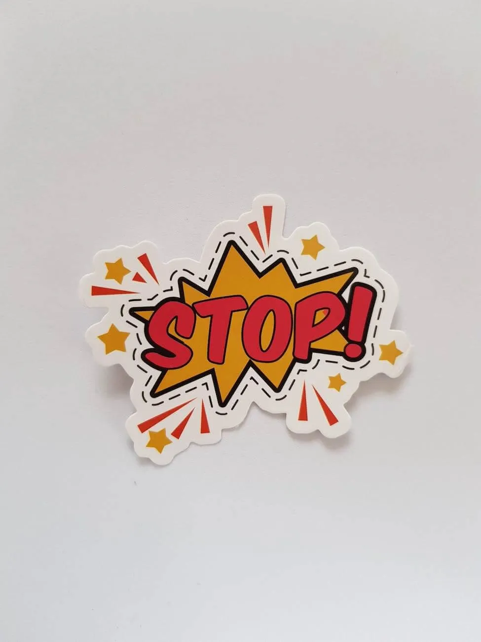 Comic-style STOP sticker on a white background